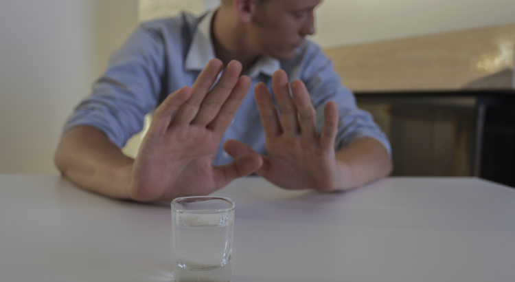 Man refuses a shot of alcohol