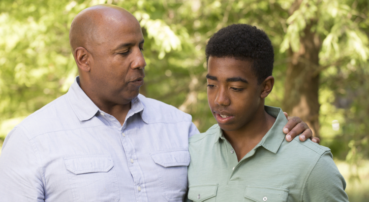 Dad explaining something to his son