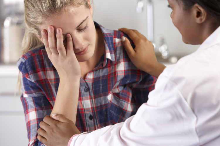 Teenage Girl Visits Doctor's Office Suffering With Depression