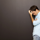 man standing with his head in his hands