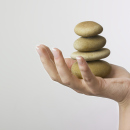 Hand holding 4 zen stones