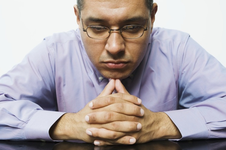 Businessman staring at pencils